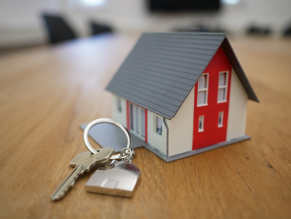 Model house and keys on a desk